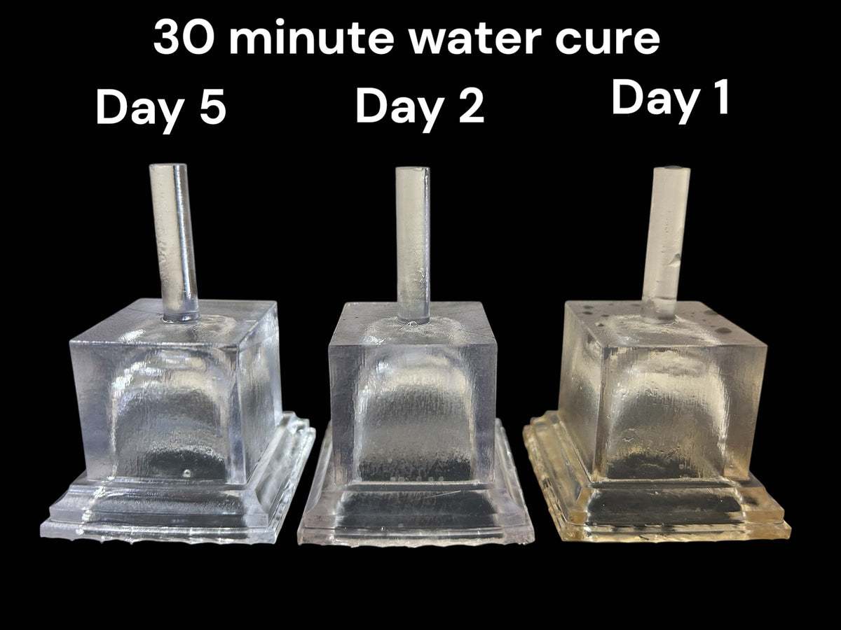 Three clear printed test parts showing results after a 30 minute water cure on day 1, day 2 and day 5
